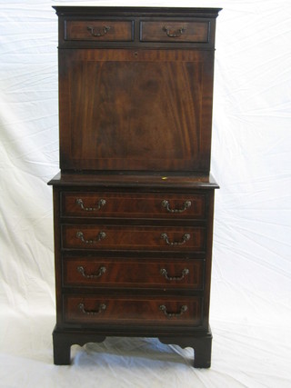 A Georgian style inlaid mahogany escritoire on chest, the upper section with moulded cornice fitted 2 short drawers, the fall front revealing a well fitted interior above 4 long drawers, raised on bracket feet 25"