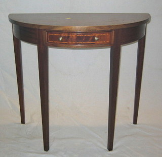 A Georgian style mahogany demi-lune table fitted a drawer on square tapering supports by M J Mine 33"