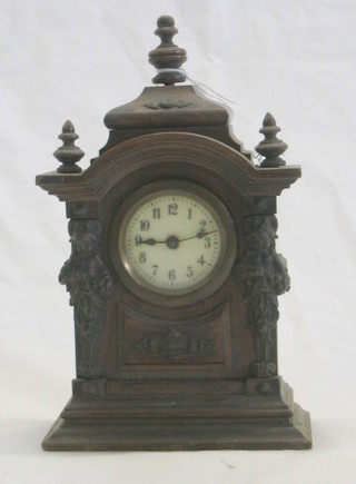 A 19th Century French bedroom timepiece with porcelain dial contained in an arched oak case with gilt metal mounts
