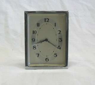 A 1930's travelling clock contained in an easel frame 5"