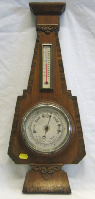 An Art Deco aneroid barometer and thermometer contained in a mahogany shaped case