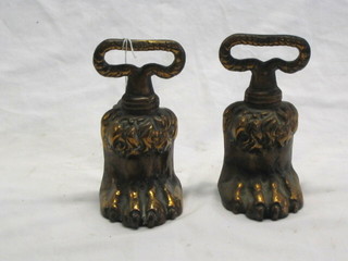 A pair of Victorian gilt metal door stops in the form of a paw feet