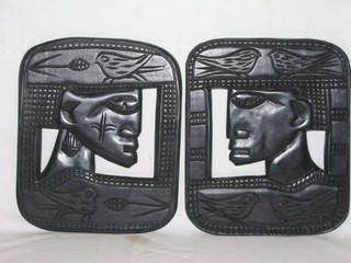 2 tribal art carved and pierced ebony panels depicting heads 14"