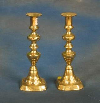 A pair of 19th Century brass candlesticks with knopped stems 10"