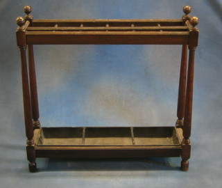 A 19th/20th Century rectangular oak umbrella stand, on turned and block supports, complete with drip tray