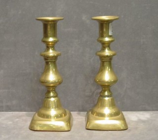 A pair of brass candlesticks 9" and a pair of ornate brass candlesticks 6"