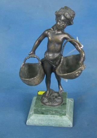 A 20th Century bronze figure of a standing girl with 2 baskets raised on a green marble base, 11"