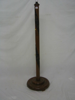 An Oriental turned and carved hardwood standard lamp