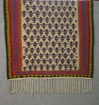 A section of carpet with cream ground and red border