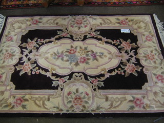 A red ground and floral patterned Indian rug 71" x 49"