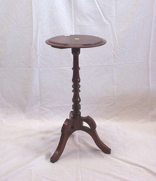 A Victorian circular mahogany wine table raised on pillar and pierced tripod supports 14"