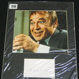 A head and shoulders portrait photograph of Herbert Lom together with a signed section of paper
