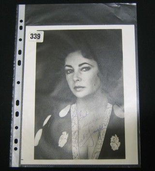 A black and white signed portrait photograph of Elizabeth Taylor inscribed To Bob Best Wishes Elizabeth Taylor