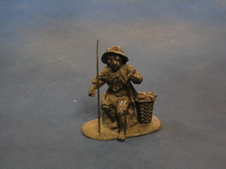 A spelter figure of a seated fisherman 