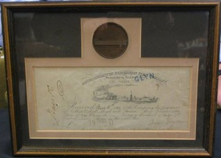 A Bright Helmstone Suspension Pier Company share certificate together with a bronze medallion commemorating the Bright Helmstone Royal Pier, framed