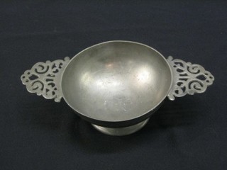 A pewter twin handled quaiche, the base marked with winged cherub and monogrammed IVM 9"
