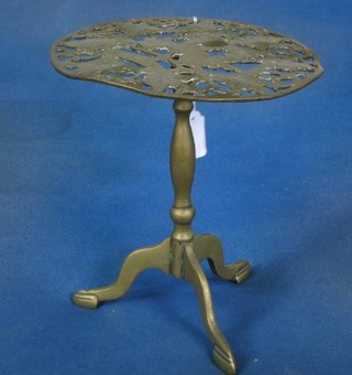 A pierced brass oval trivet