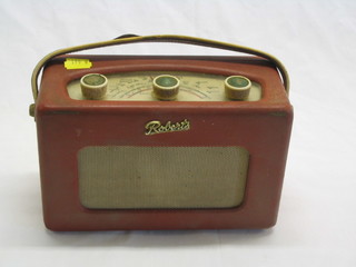 A Roberts model R200 portable radio contained in a red fibre case
