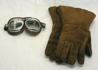 A pair of sheep skin gauntlets and a pair of goggles