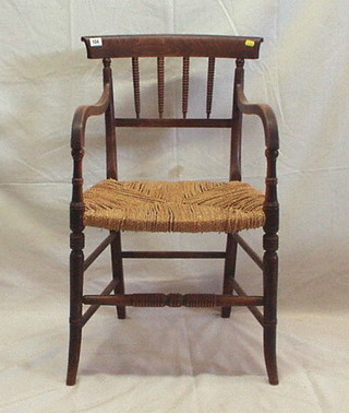 A 19th Century beech framed bar back desk chair with bobbin turned decoration and woven rush seat, on turned supports