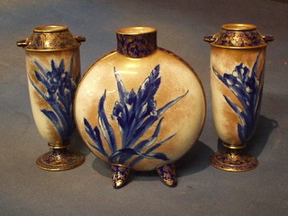 A Doulton Burslem Flo Bleu garniture comprising moon flask, raised on 4 feet 9" (unmarked) and a pair of twin handled vases, the bases marked Doulton Burslem England, impressed X 41 9!