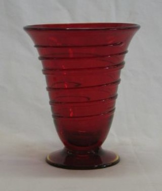 A Whitefriars Ruby Footed Ribbon Trail vase raised on a circular base 5 1/2"