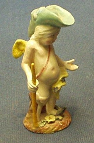 A 19th Century miniature porcelain figure of a boy with stick (f and r)