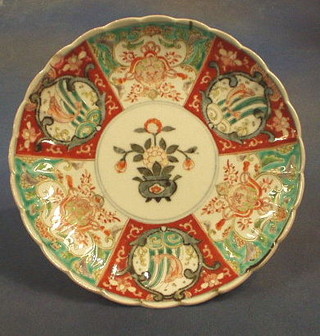 A 19th Century Japanese Imari porcelain plate, the centre decorated an urn of flowers within panelled border 10" (slight chip to rim)