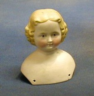 A biscuit porcelain dolls head 4" (cracked)