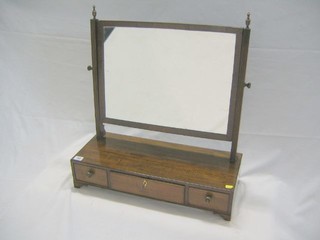 A 19th Century rectangular plated dressing table mirror, raised on a mahogany swing frame, the base fitted 1 long and 2 short drawers, on bracket feet 24"