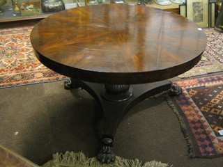 A William IV circular snap top breakfast table with plain mahogany top, raised on a turned florette column with triform base and paw feet 48"