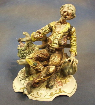 A Capo di Monte figure of a seated tramp 12"