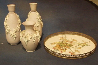 A 3 piece opaque porcelain garniture of vases with vinery encrusted decoration and tray with plated mounts