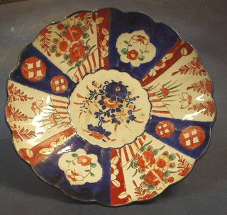 A 19th Century Japanese Imari porcelain plate, the centre decorated a vase of flowers with lobed and panelled body 11"