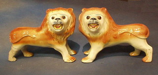 A pair of 19th Century Staffordshire figures of standing lions with glass eyes 12" (1 f and r)