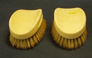 A pair of ivory backed military hair brushes