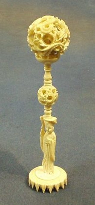 A pierced ivory puzzle ball and stand
