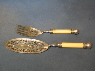A pair of Victorian pierced silver plated fish servers with ivory handles