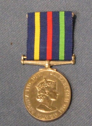 A QEII issue Civil Defence Long Service medal with cardboard carton and 4 epaulettes