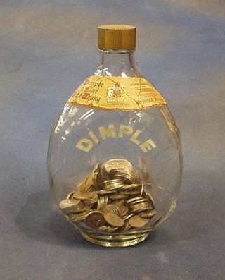 A whisky bottle and contents of sixpences