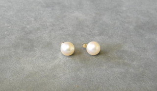 A pair of pearl ear studs
