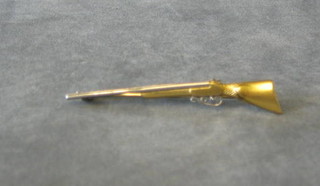 An 18ct gold white and yellow gold bar brooch in the form of a shot gun