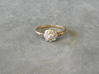 A lady's 18ct gold cluster ring set 9 diamonds and 2 diamonds to the shoulders
