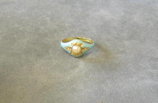 A gold dress ring with turquoise enamelled decoration and set a demi-pearl surrounded by diamonds