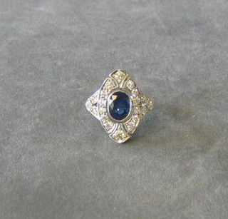A lady's white gold dress ring set an oval cut sapphire surrounded by numerous diamonds (approx 1 ct/1.60ct)
