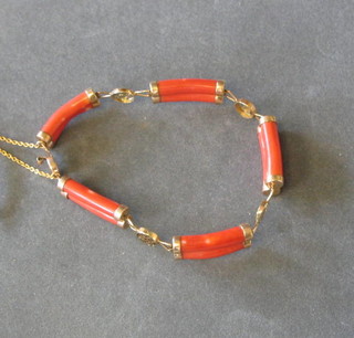 An Oriental gold and polished coral bracelet