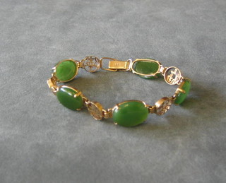 An Oriental gold and jade coloured bracelet