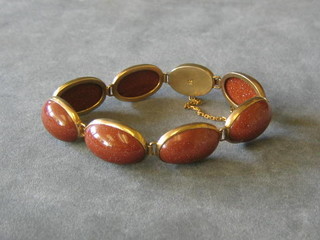An Oriental gold bracelet set cabouchon cut hard stones