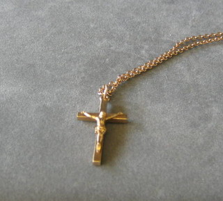 A 9ct gold crucifix hung on a gold chain
