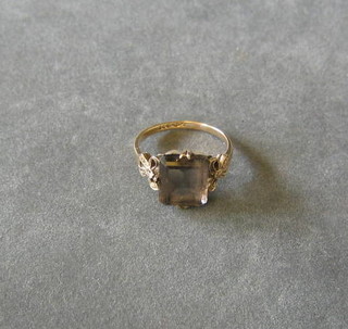 A gold dress ring set a rectangular cut smokey quartz